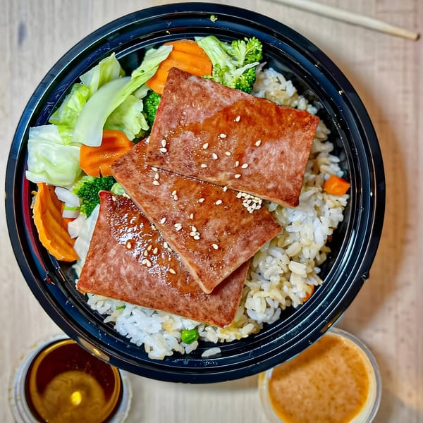 Tokyo Teriyaki's Spam Musubi bowl with rice, vegetables, and three slices of spam topped with sesame seeds.