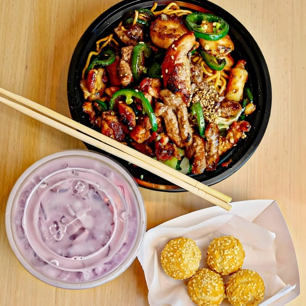 Tokyo Teriyaki meal with noodles, meat, green peppers, sesame balls, and a purple drink.